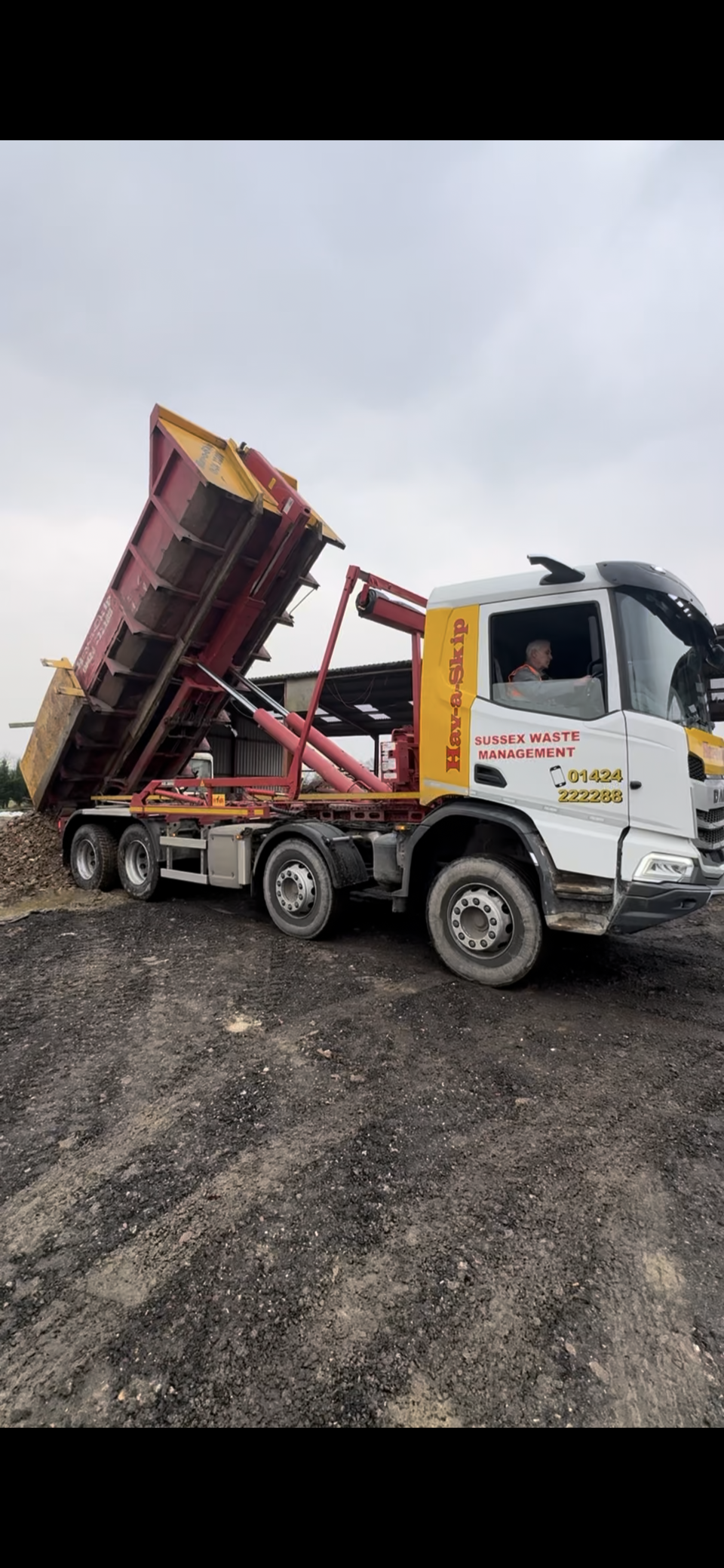 Skip lorry tipping at yard